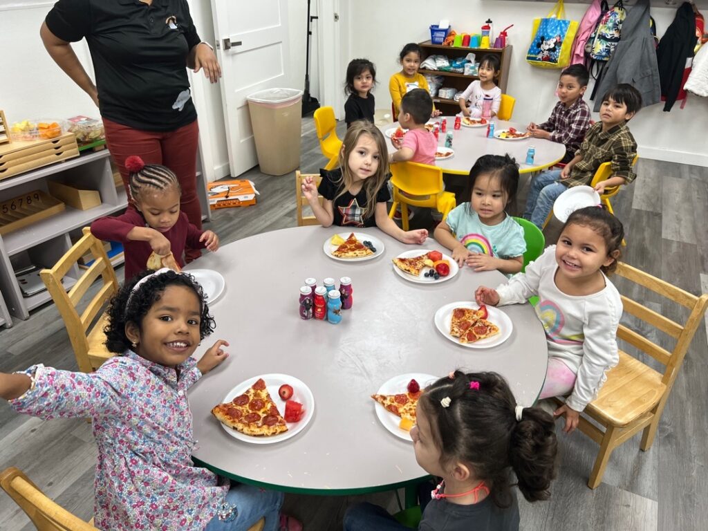 Children sharing lunch at a classroom table at Sunshine Daycare in Lewisville